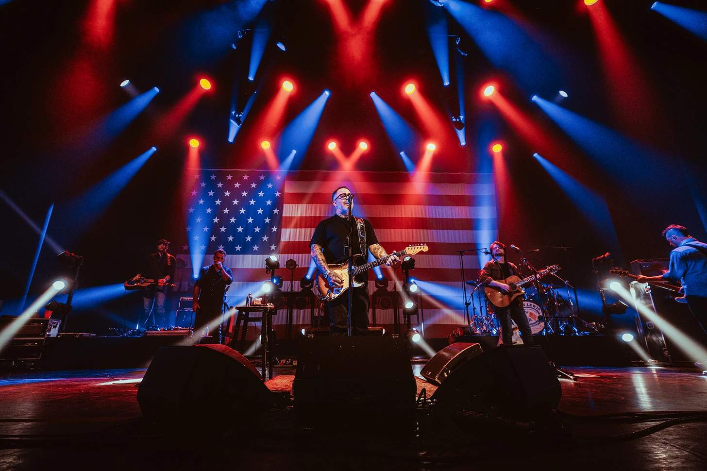 Aaron Lewis on stage singing and playing guitar