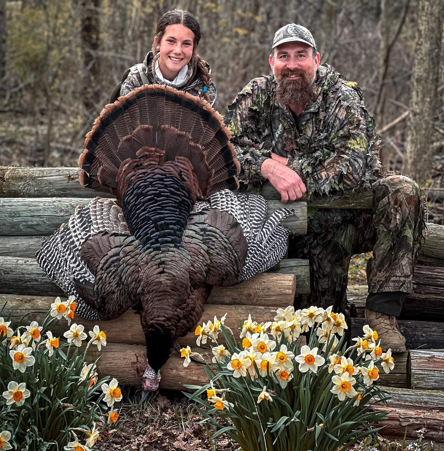 Matt Light celebrating with Ohio Youth Turkey Hunt participant Clair after a successful hunt.