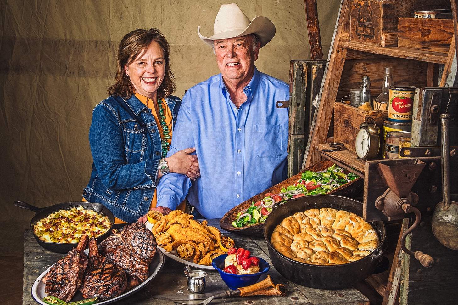 Tom Perini and his wife Lisa with a spread of food