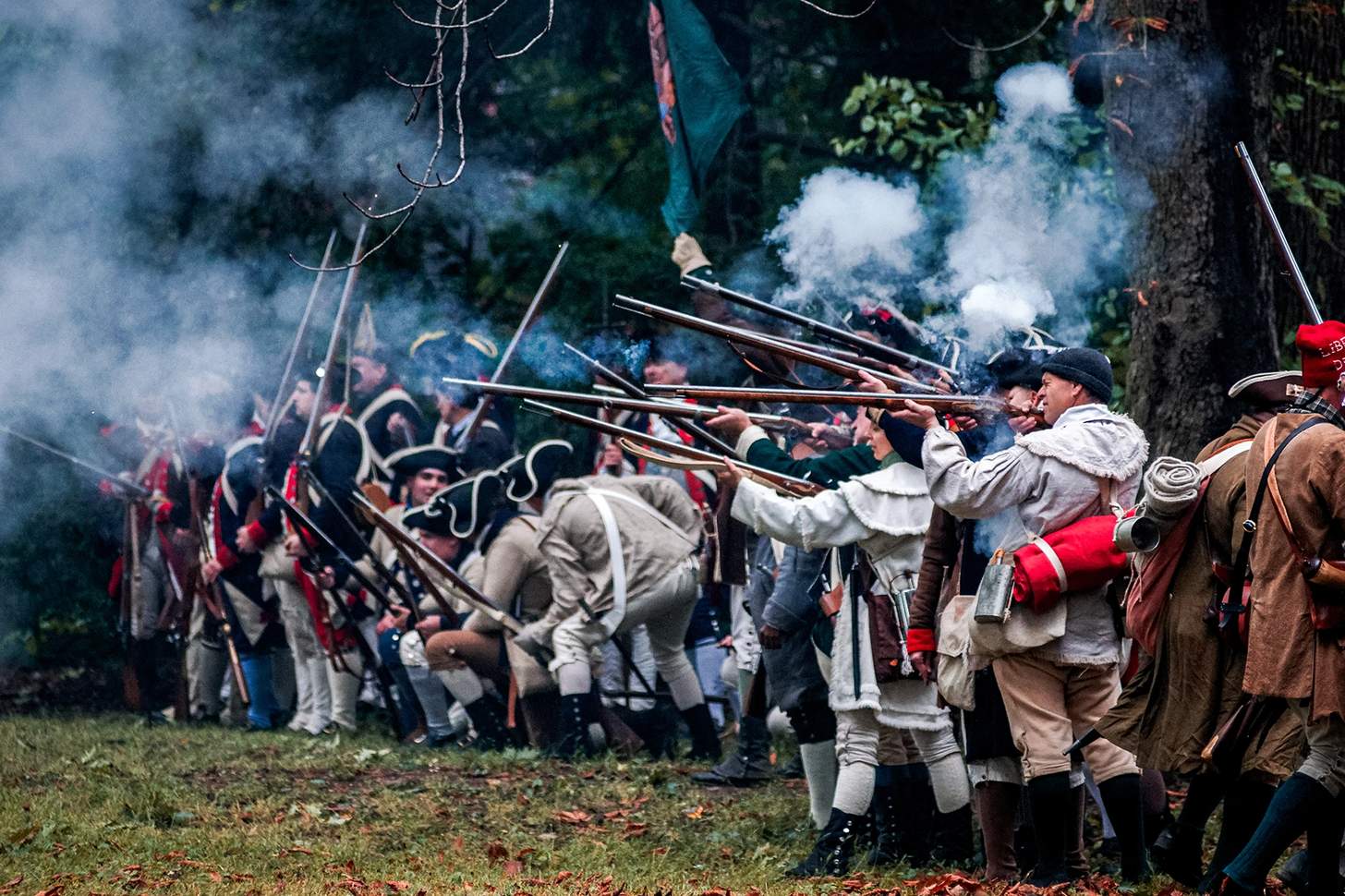 revolutionary war reenactors firing muskets