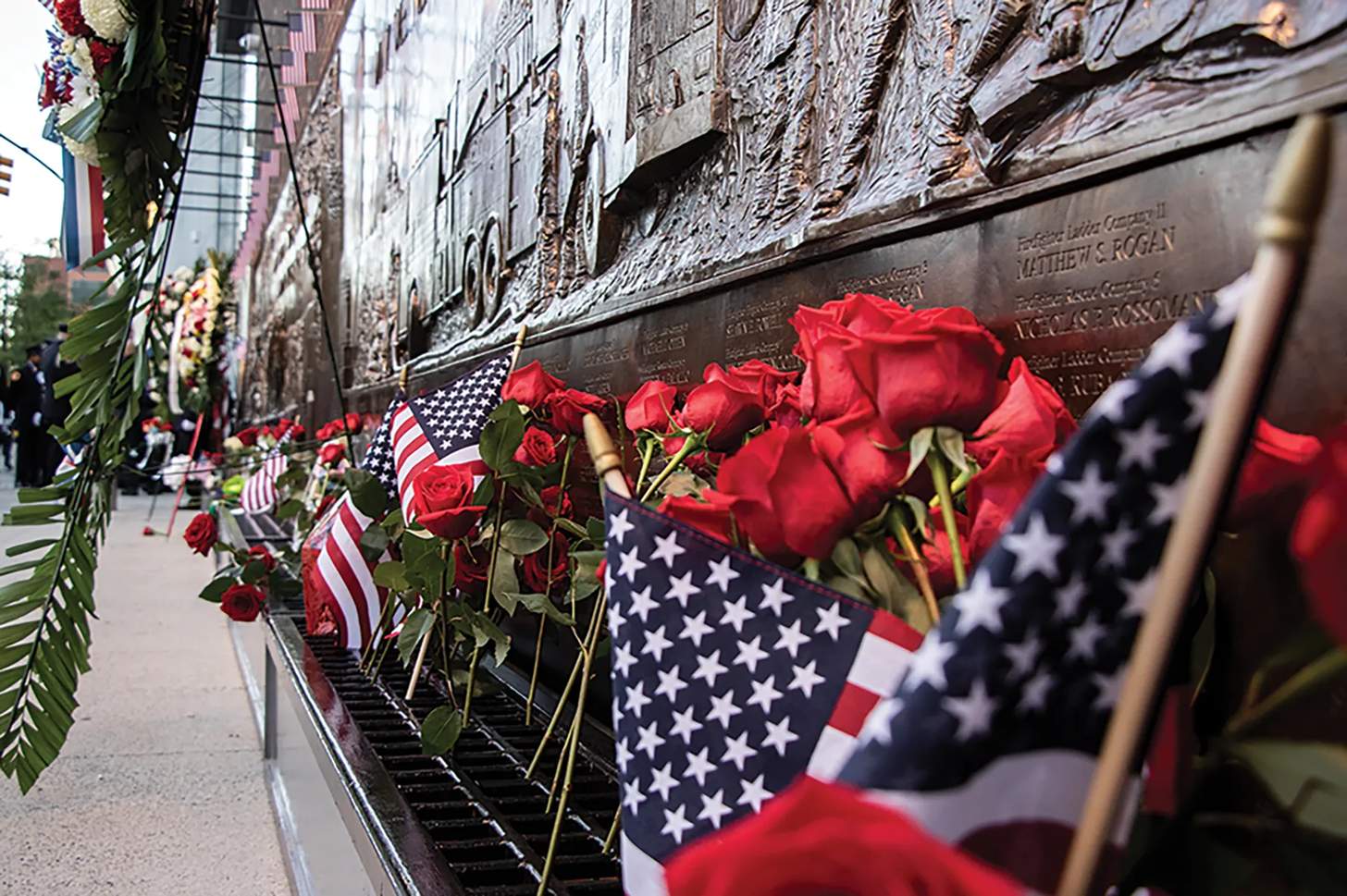 flowers and flags laid at a 9/11 memorial