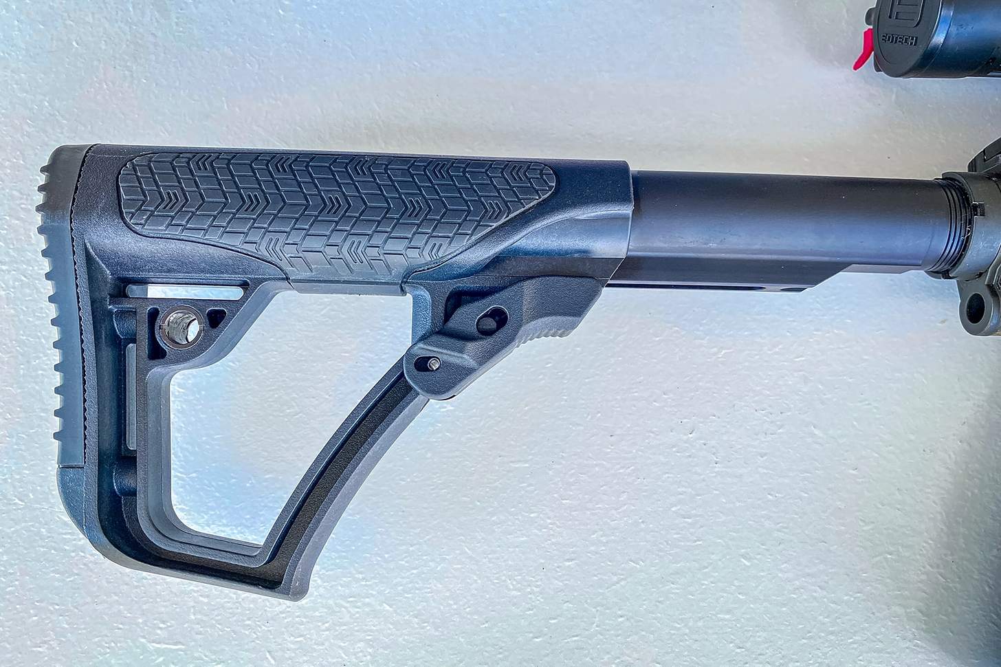 rifle buttstock with soft touch overmolding