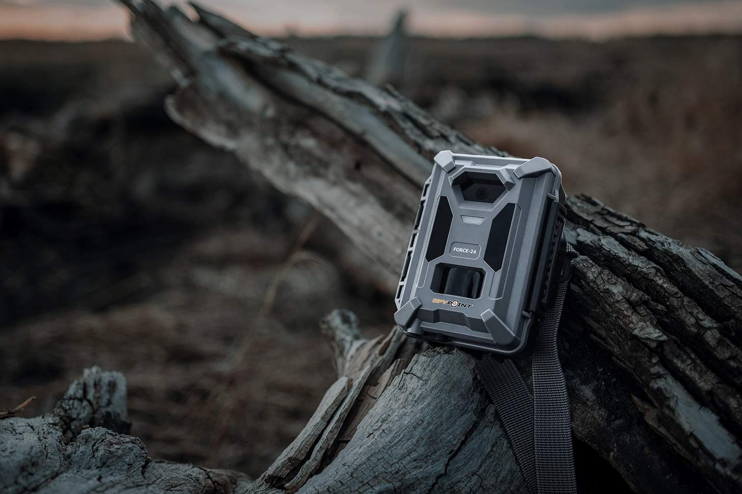 Spypoint FORCE-24 trailc cam on a piece of dry wood