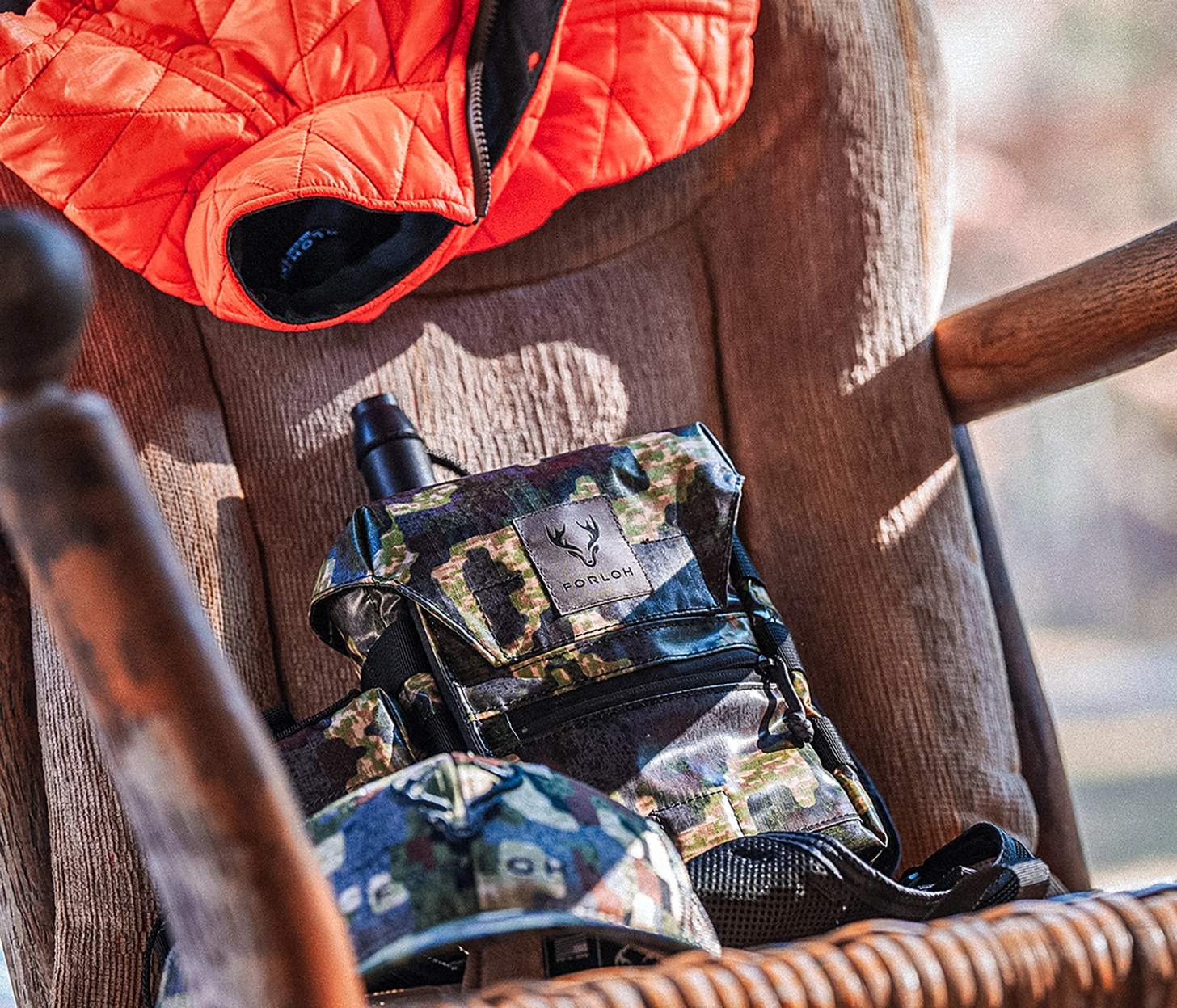 a FORLOH chest pack on a chair with a blaze orange vest