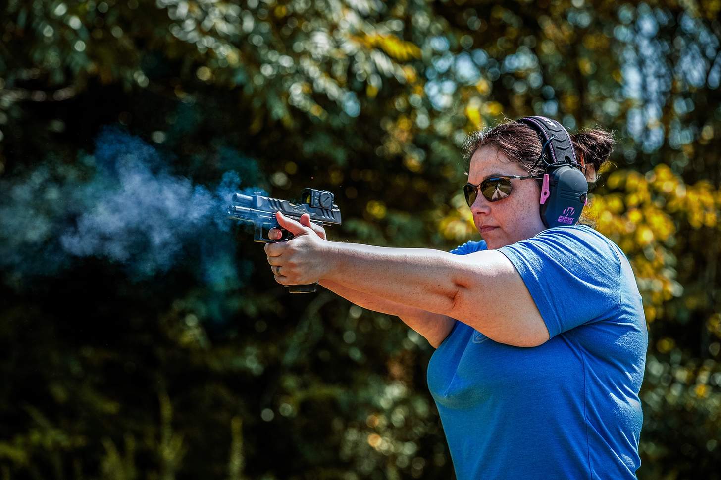 A woman firing the Walther PDP F Pro ACRO