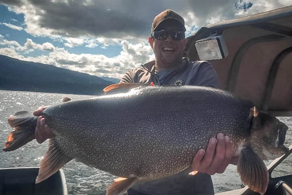 Aaron Goettsche with the new Idaho State Record Lake Trout he caught in July 2025 - Idaho Fish and Game