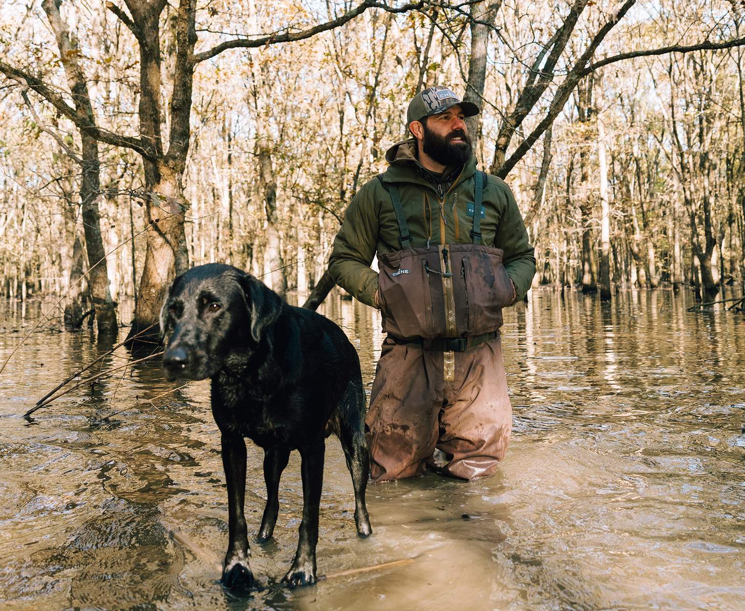 on a duck hunt in flooded timber with a hunting dog