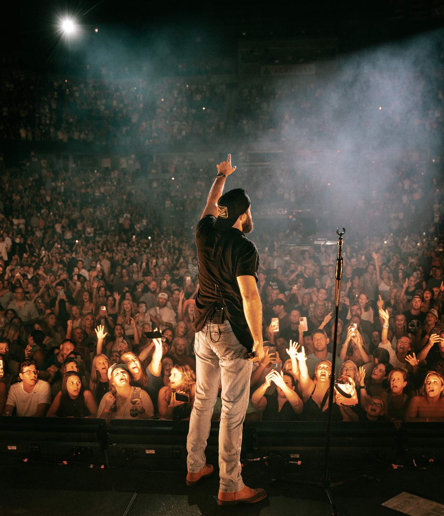 Jordan Davis performing on stage to a huge crowd