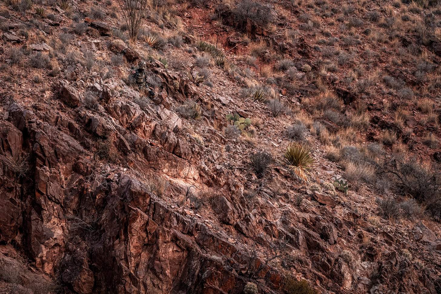 KUIU camo pattern on a hunter in an arid landscape