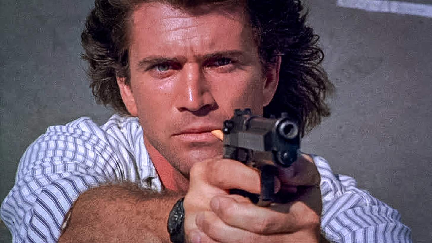 Sgt. Martin Riggs (Mel Gibson) aims his Beretta 92F pistol at a sniper.