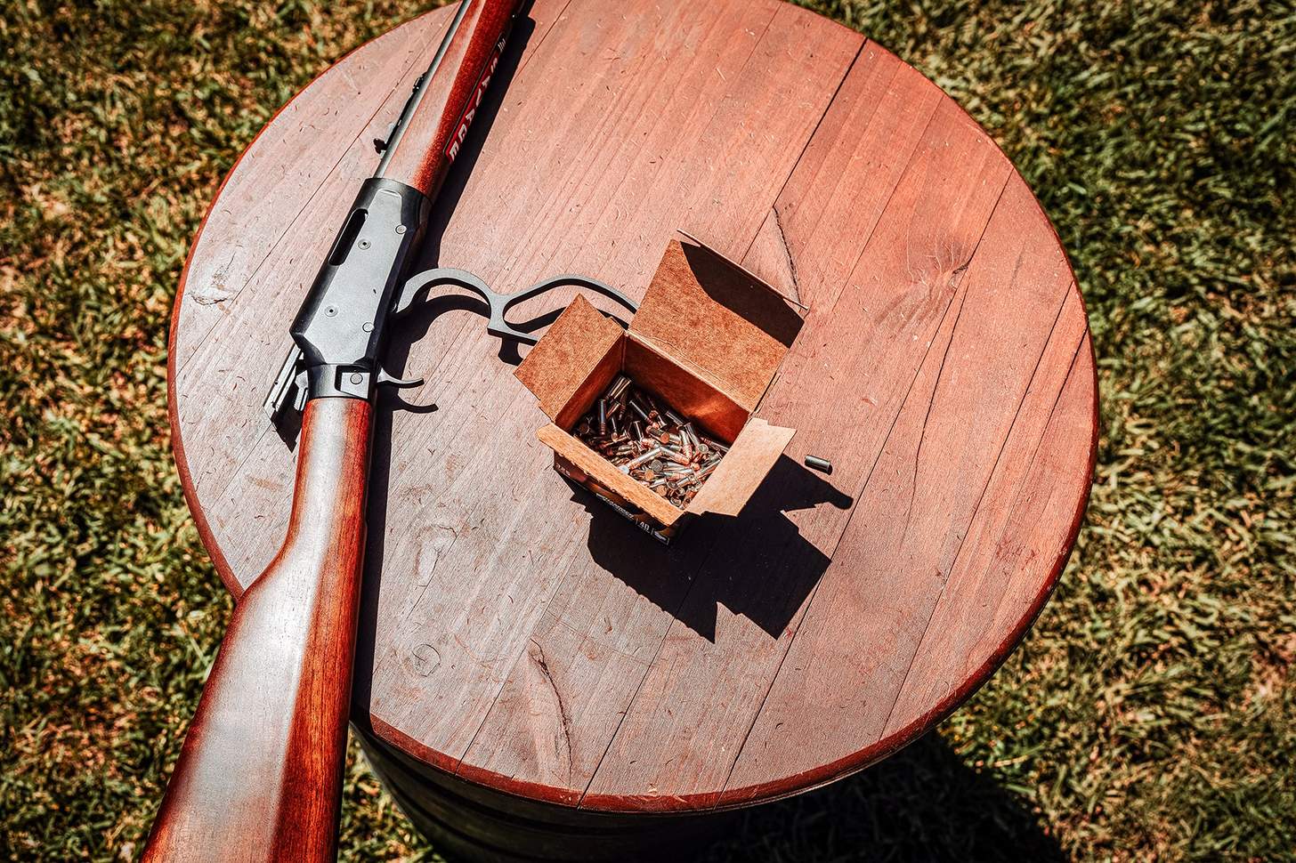 Savage Revel DLX rifle on a table with an open box of .22LR ammo
