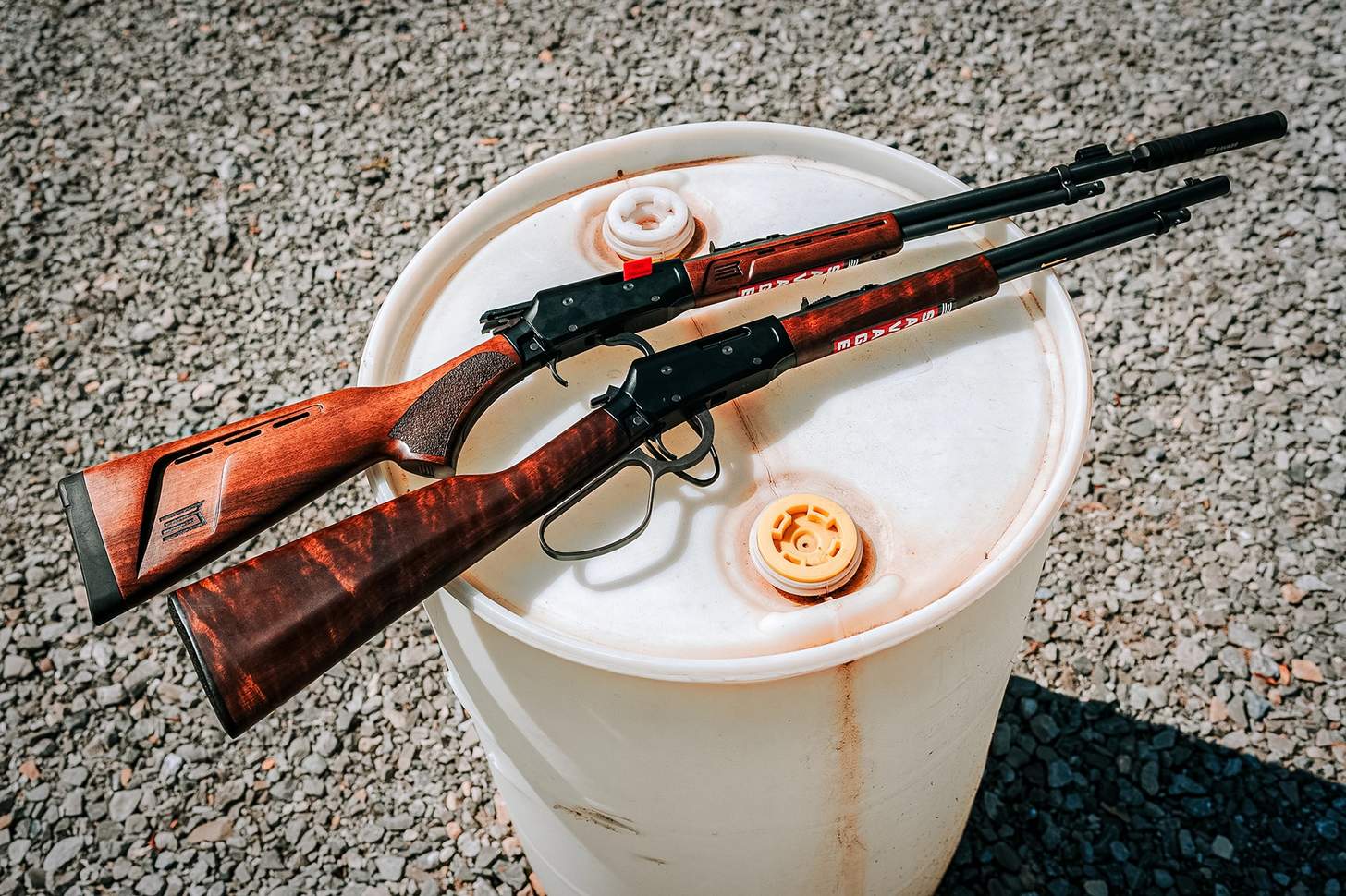 two Savage Revel DLX rifles on a 55-gallon drum at the shooting range