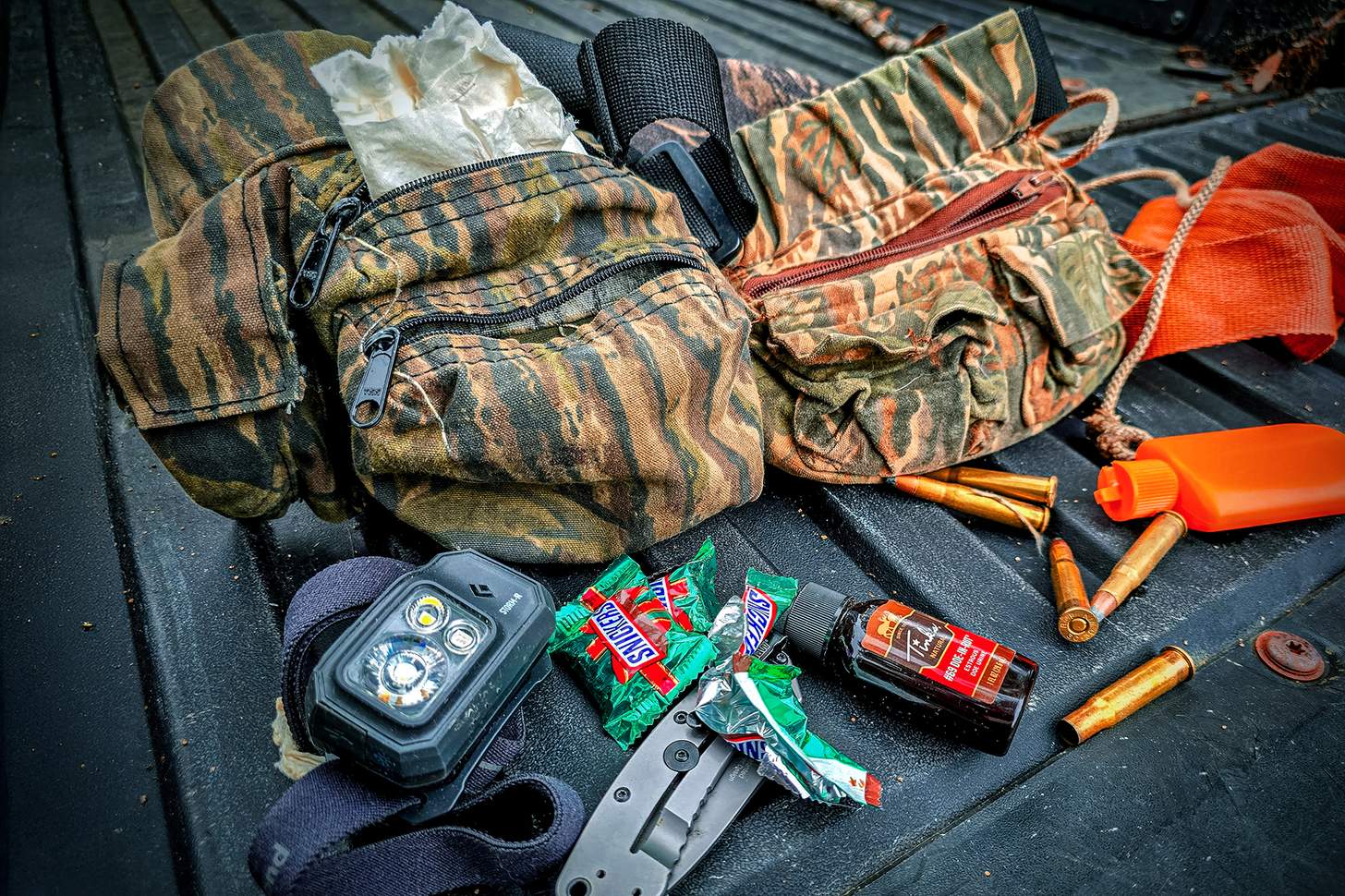 bowhunting gear laid out in a truck bed