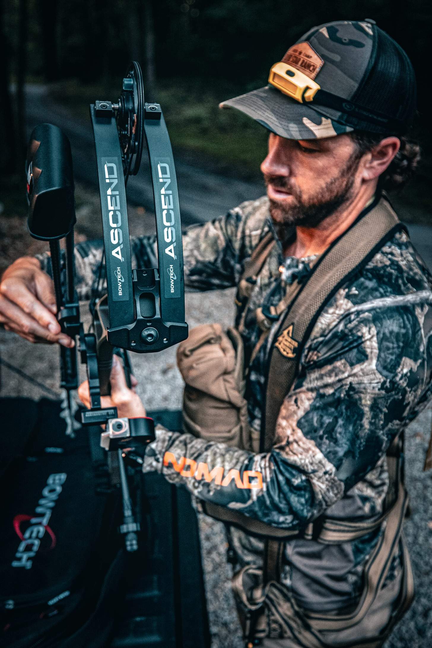 a man affixing a quiver to the Bowtech Ascend