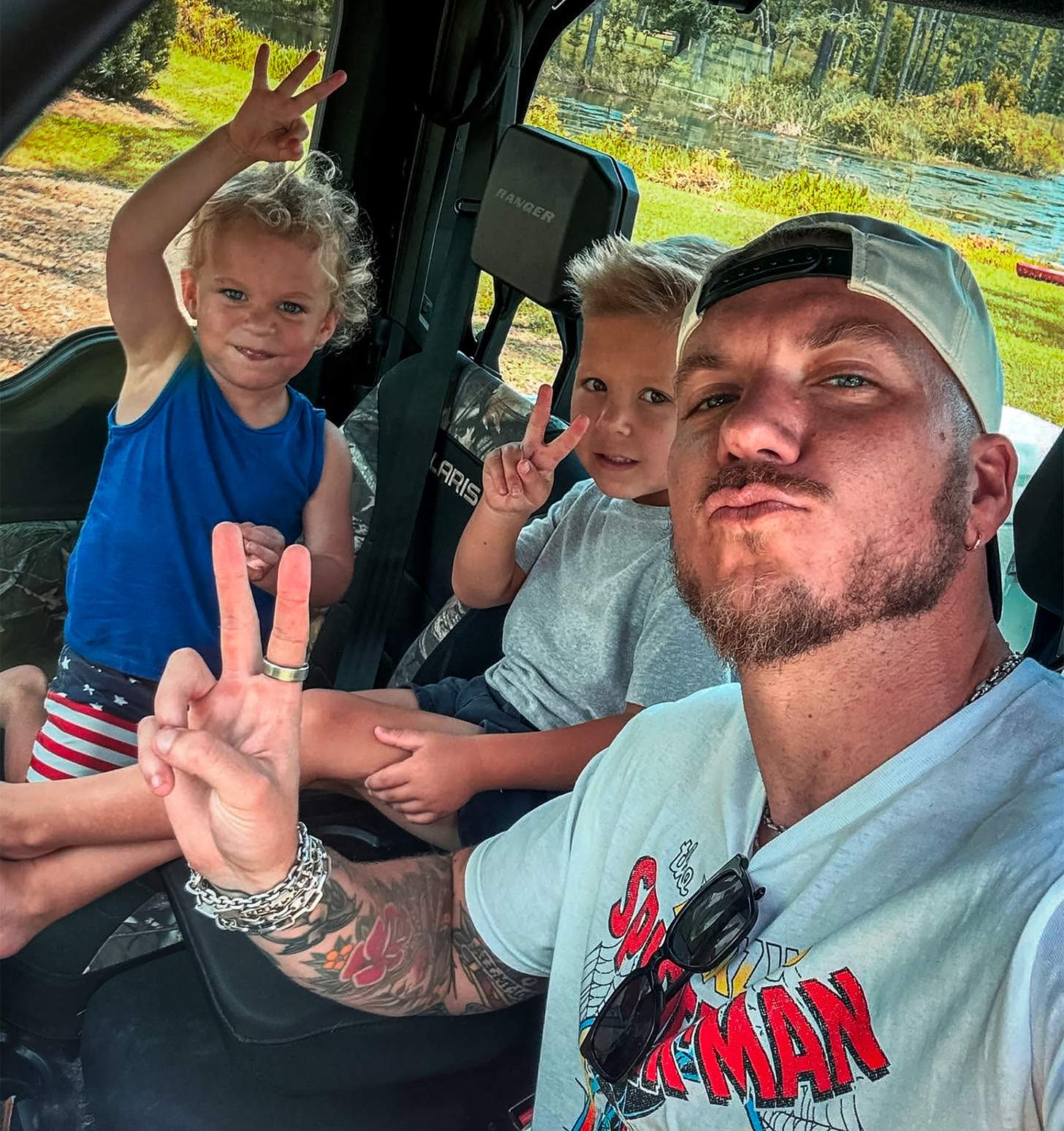 Brandon Lake with his kids in an ATV