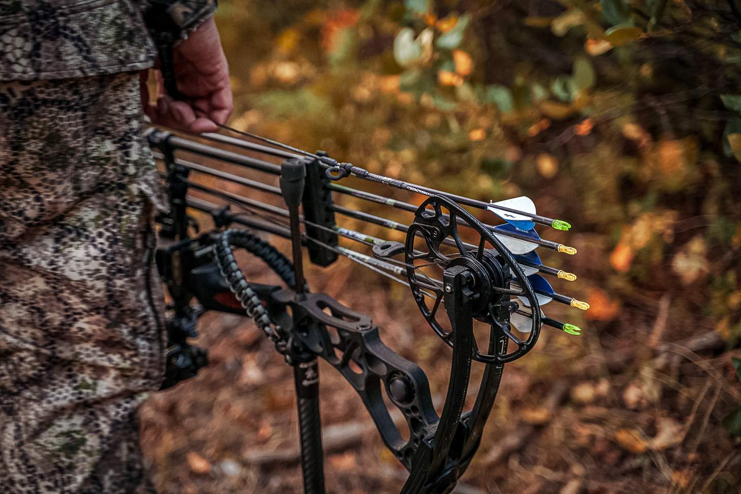 cam of a compound bow being carried in the woods - how to choose a compound bow