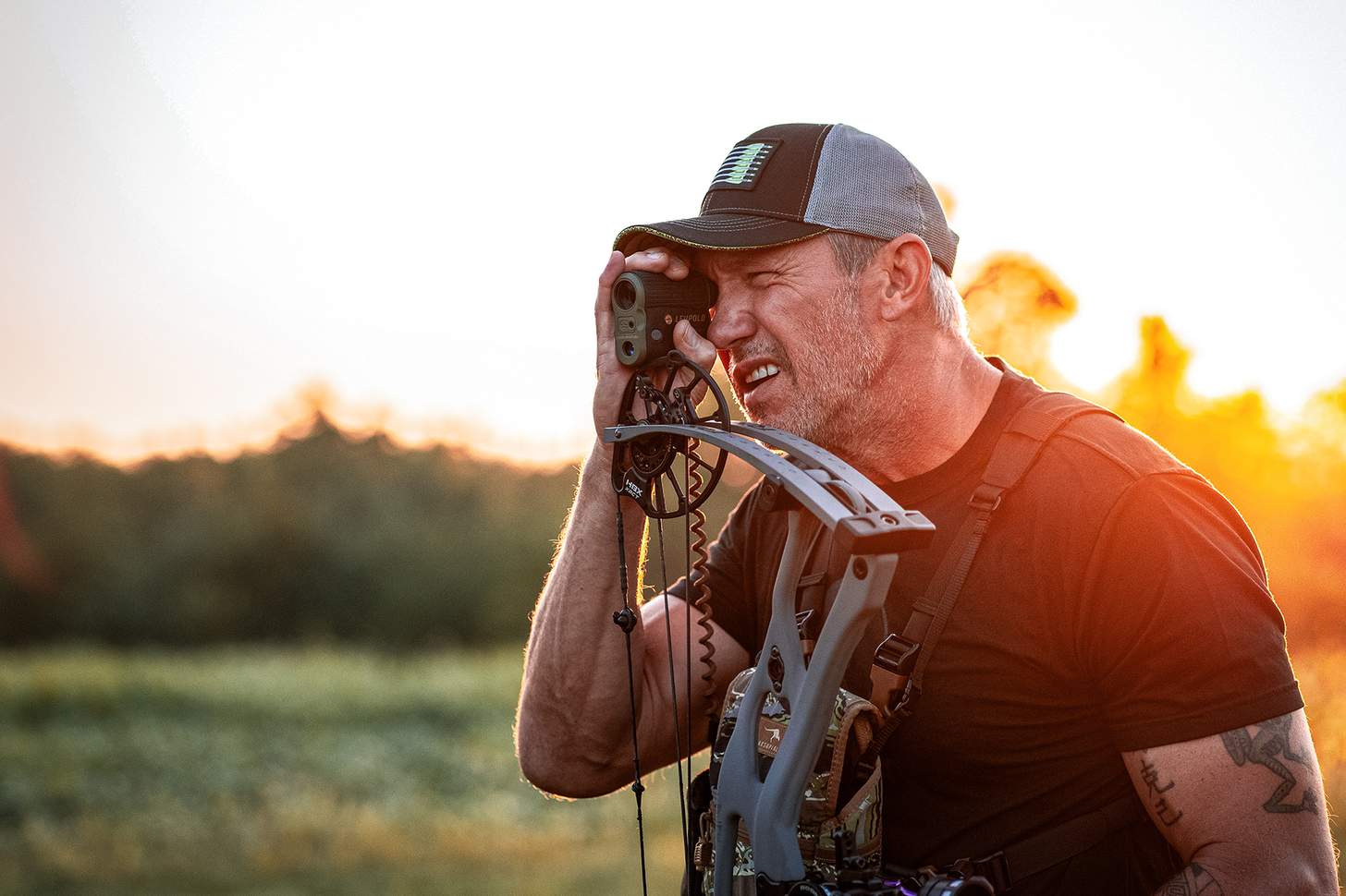 John Dudley looking through a rangefinder