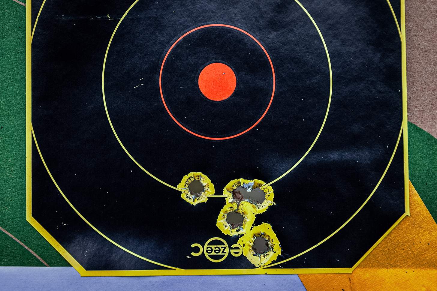 target with grouping of bullet holes
