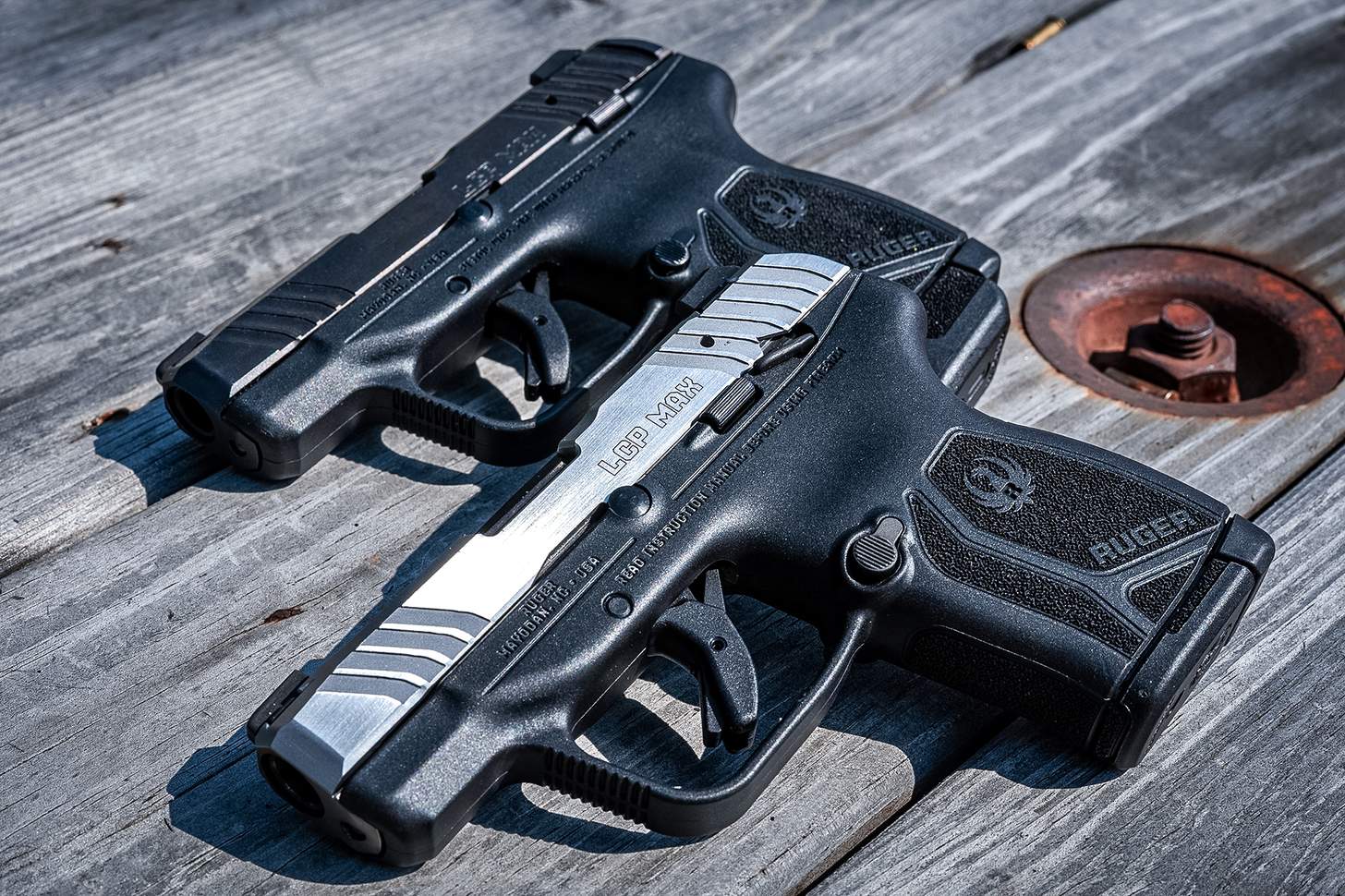 Ruger LCP Max pistol with a stainless slide and black slide on a wooden table