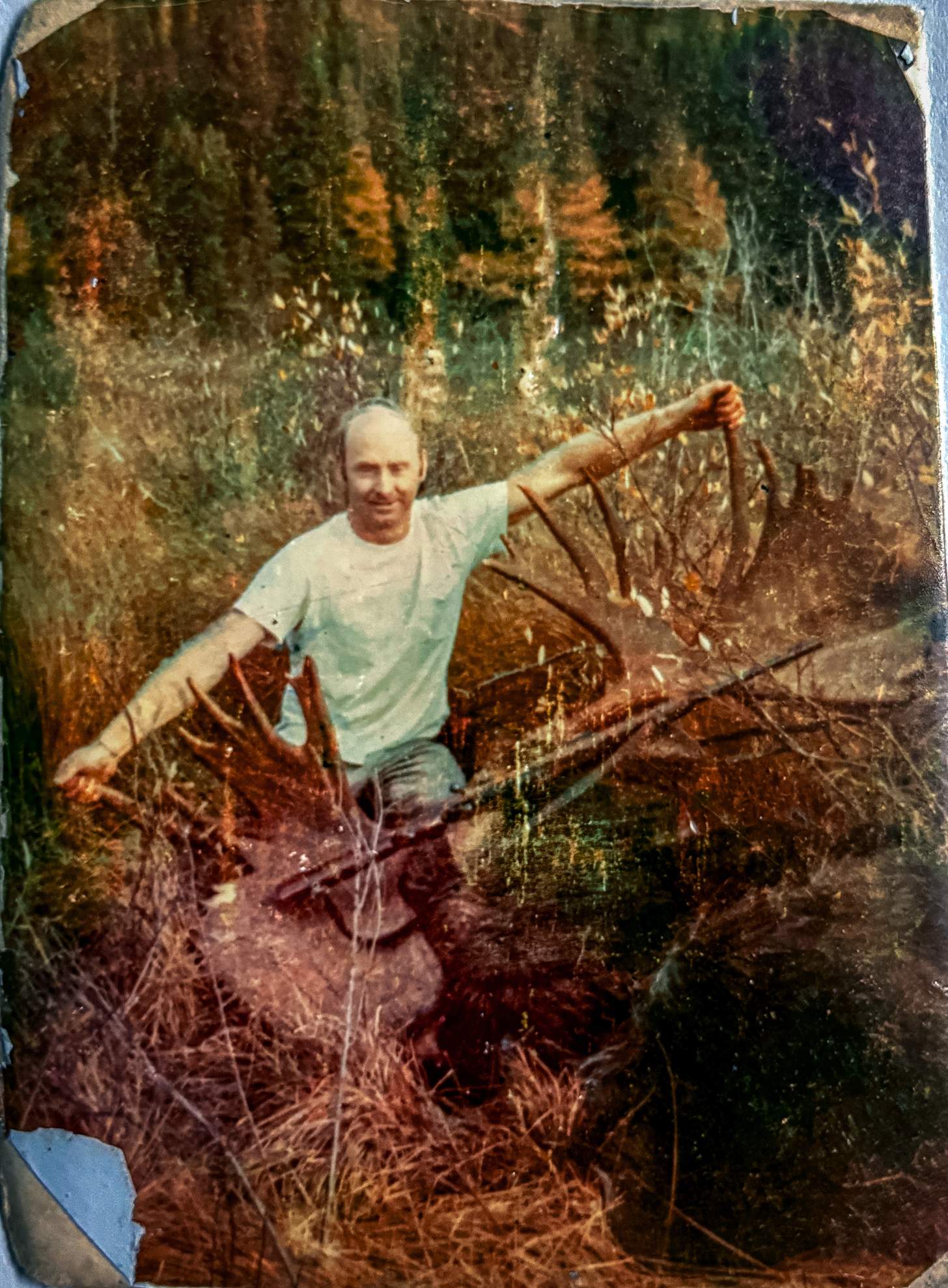 an old snapshot of Ed Hall in the field with Old Ugly and the rifle Hall shot him with