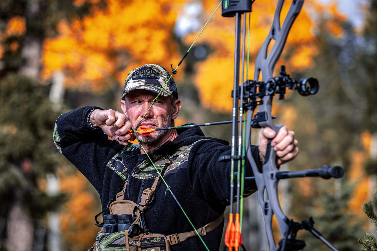 John Dudley at full draw in the field