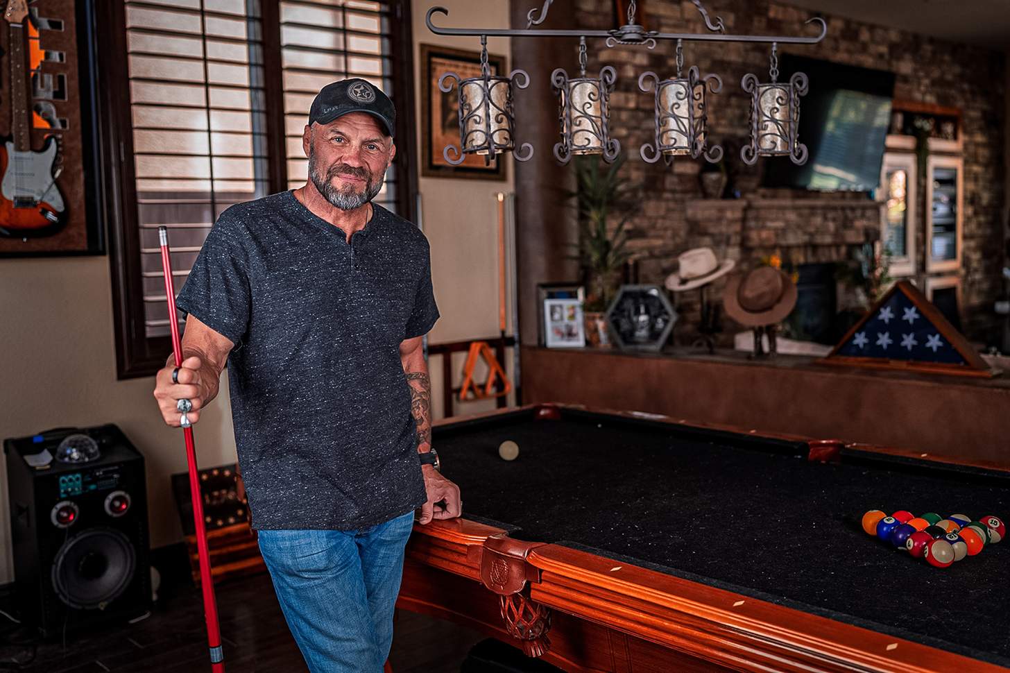 Randy Couture standing next to the pool table in his home