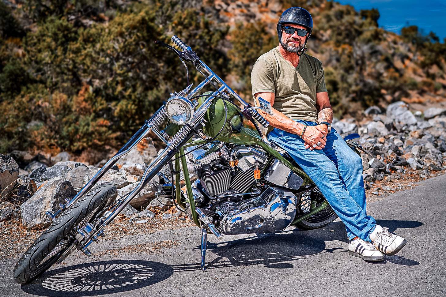 Randy Couture leadning on his custom motorcycle