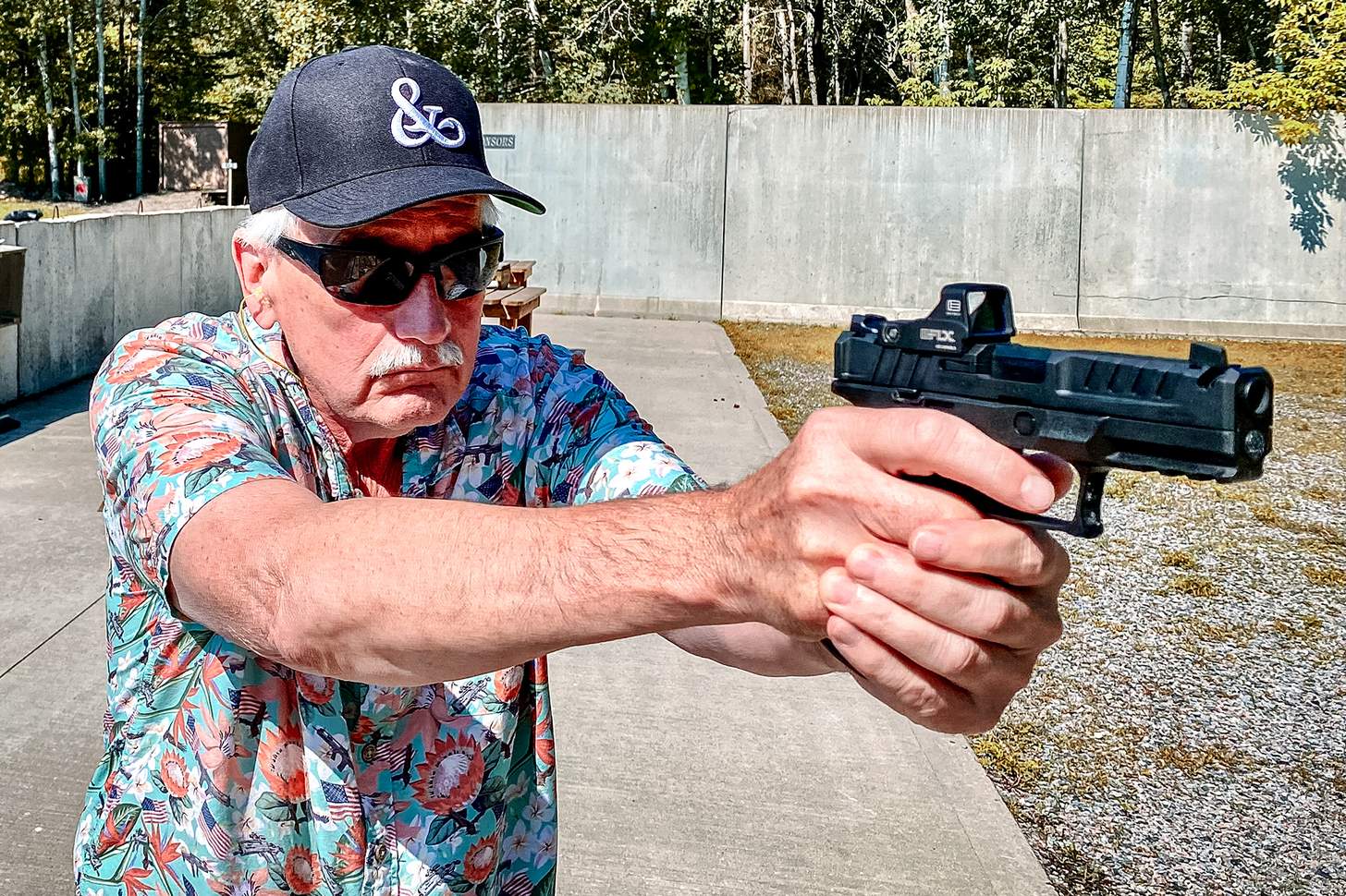 the author shooting the new Springfield Echelon 4.0C Comp 9mm handgun with an EOTech EFLX red dot