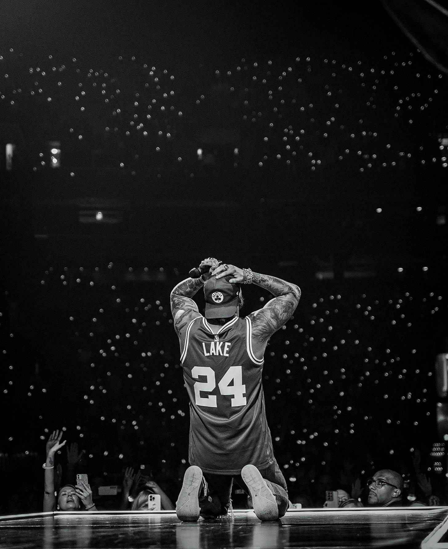 Brandon Lake kneels on stage