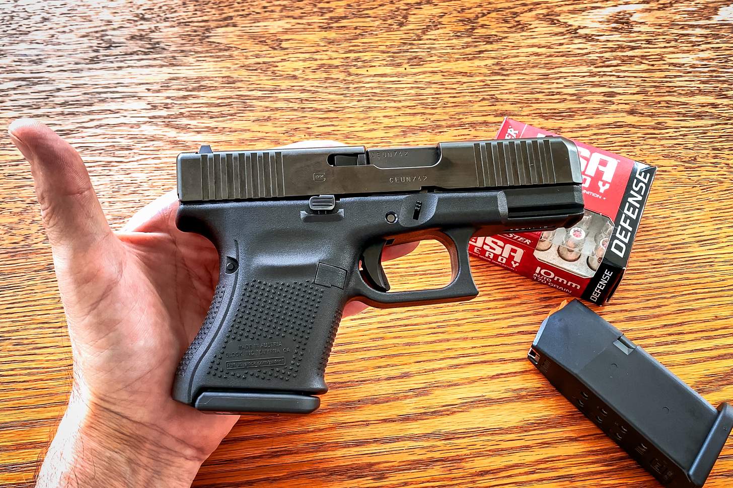 Glock G29 Gen5 in hand with USA Ready defense 10mm ammo