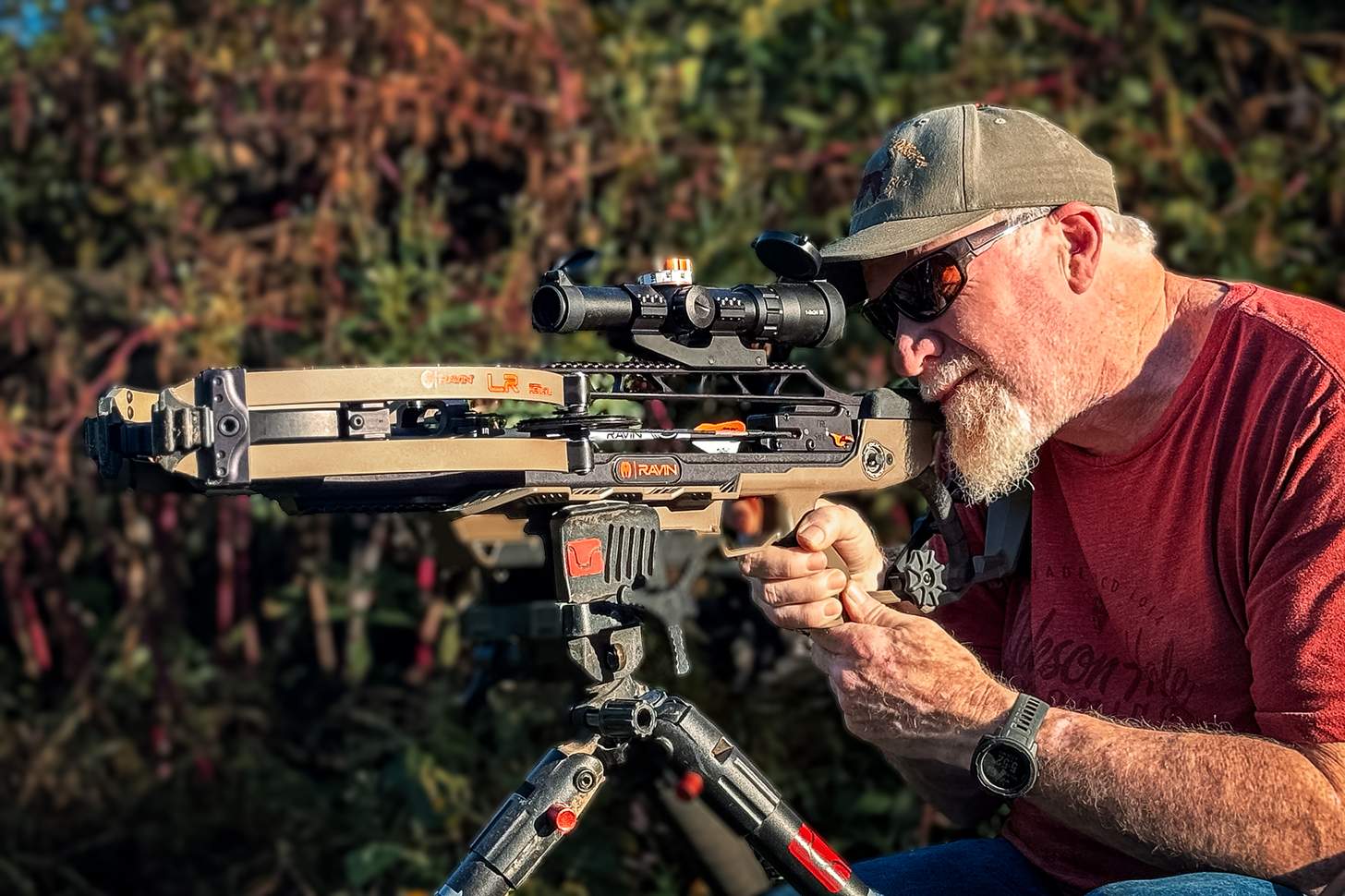 man shooting a Ravin LR crossbow from a tripod