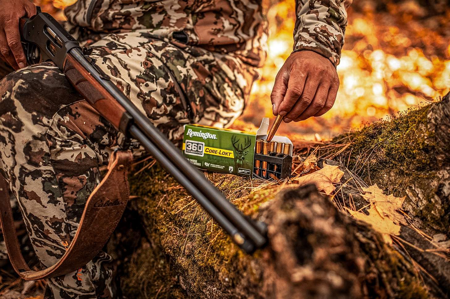 a hunter pulling rounds of Remington Core-Lokt .360 buckhammer ammo from a box