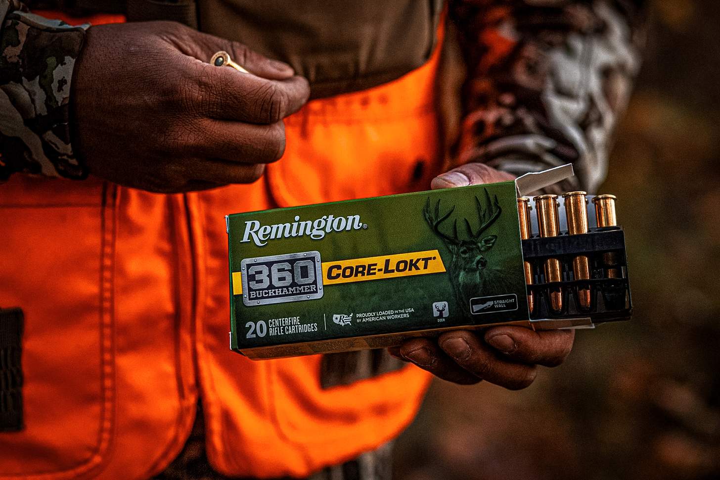 a hunter pulling rounds of Remington Core-Lokt .360 buckhammer ammo from a box