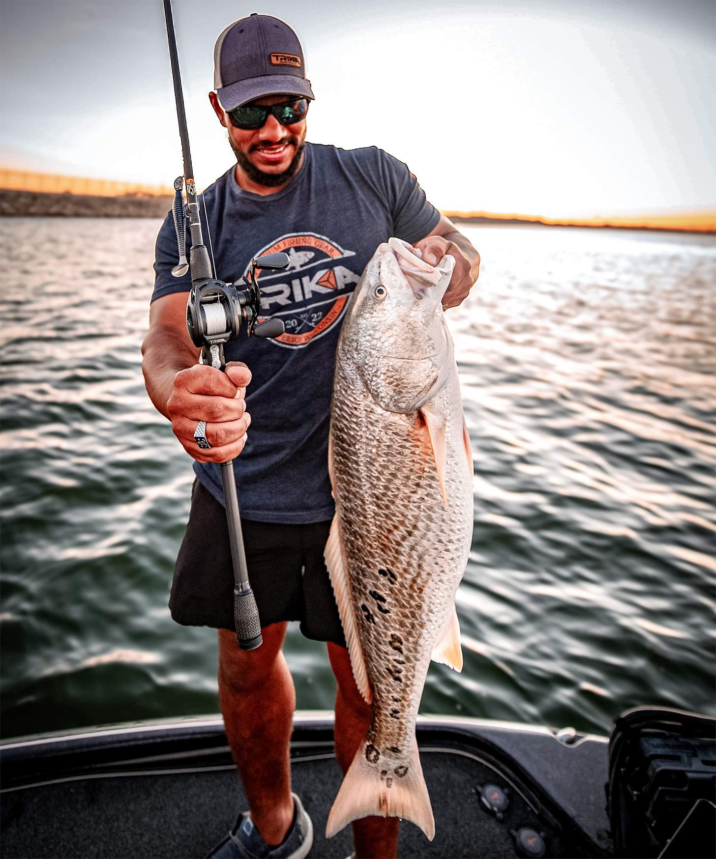 man with trika rod and reel and bass