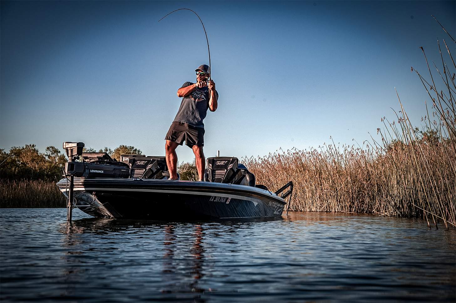 a man hooking a fish with a Trika rod