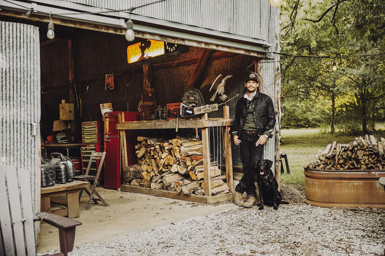 Chase Rice with his dog by the barn