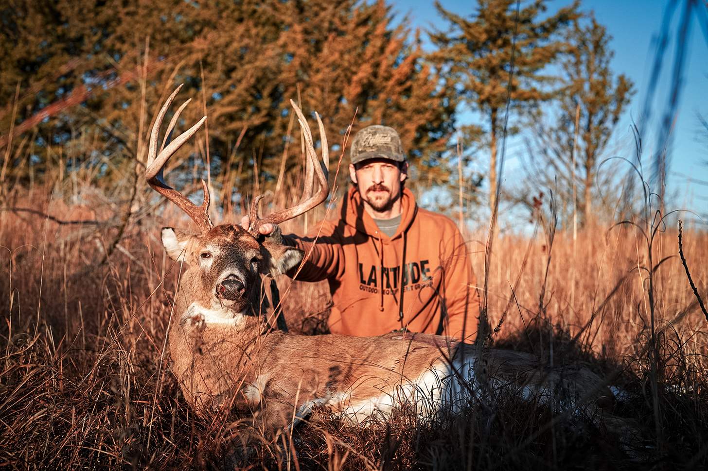 a hunter with a nice whitetail buck