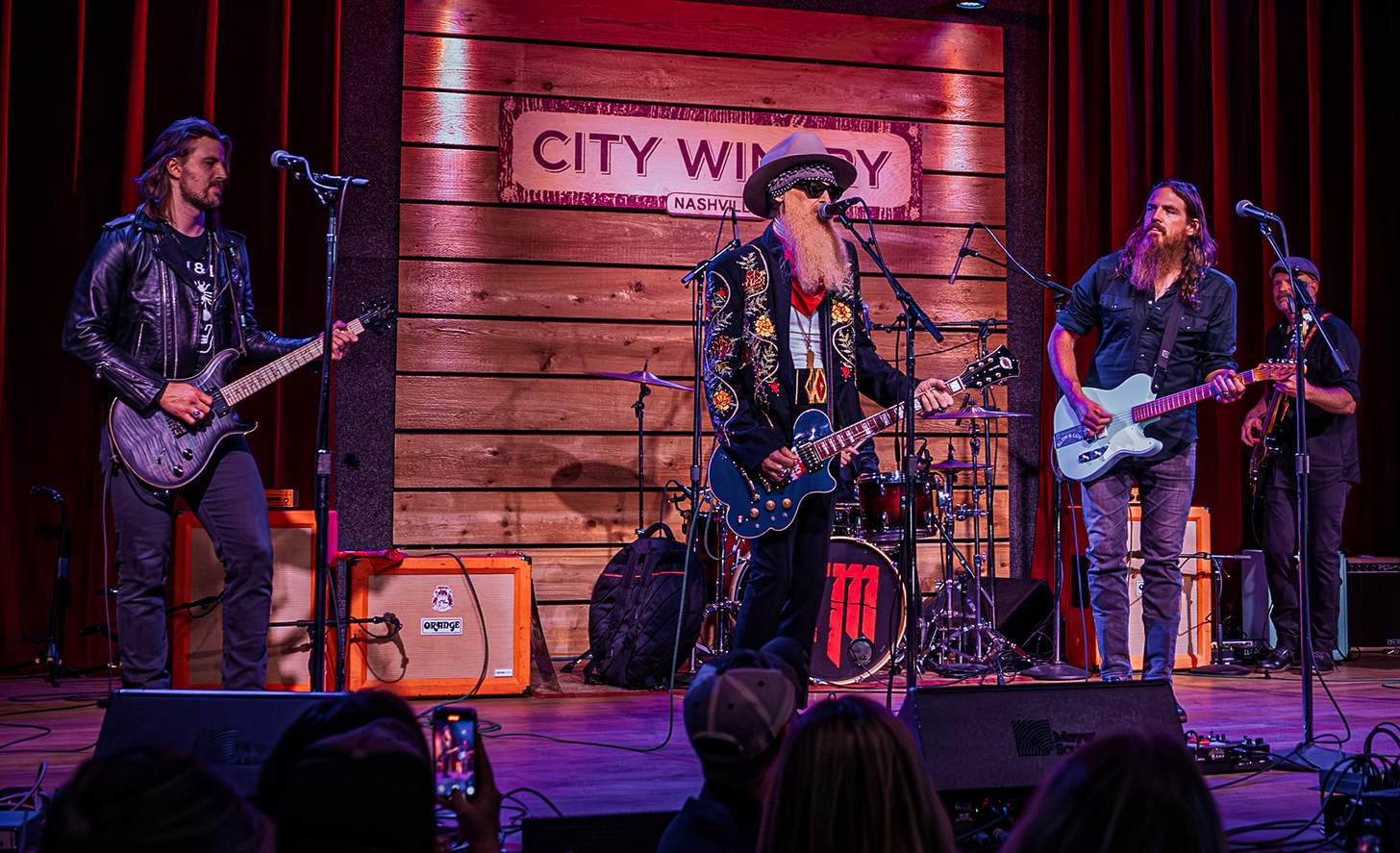 Billy Gibbons of ZZ Top on stage with Tim Montana and others. 
