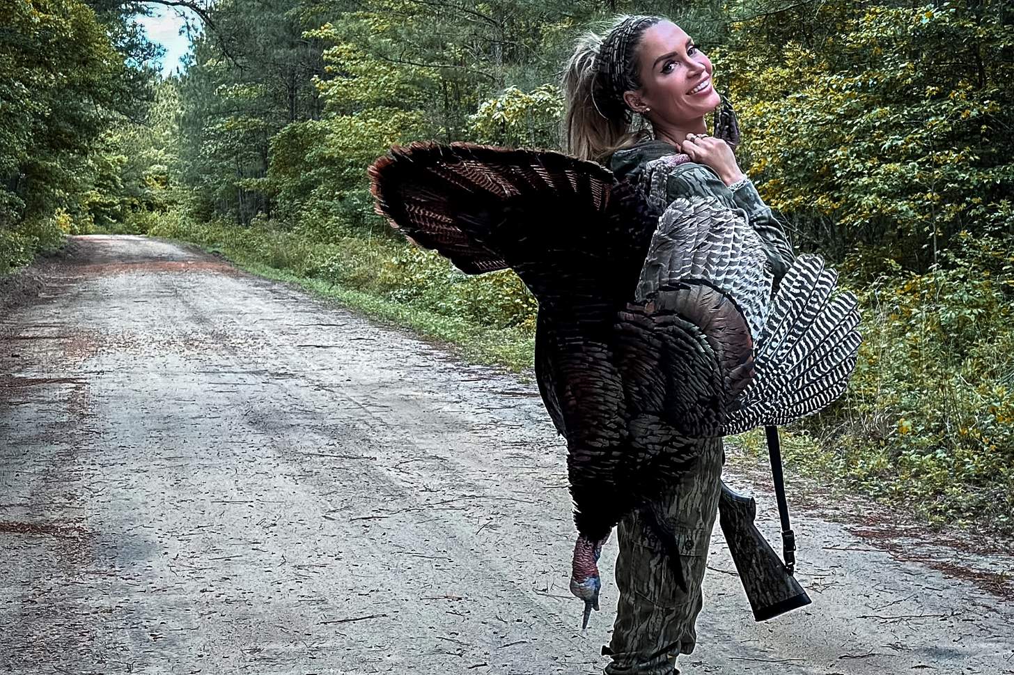 lauren brown with a turkey and a shotgun
