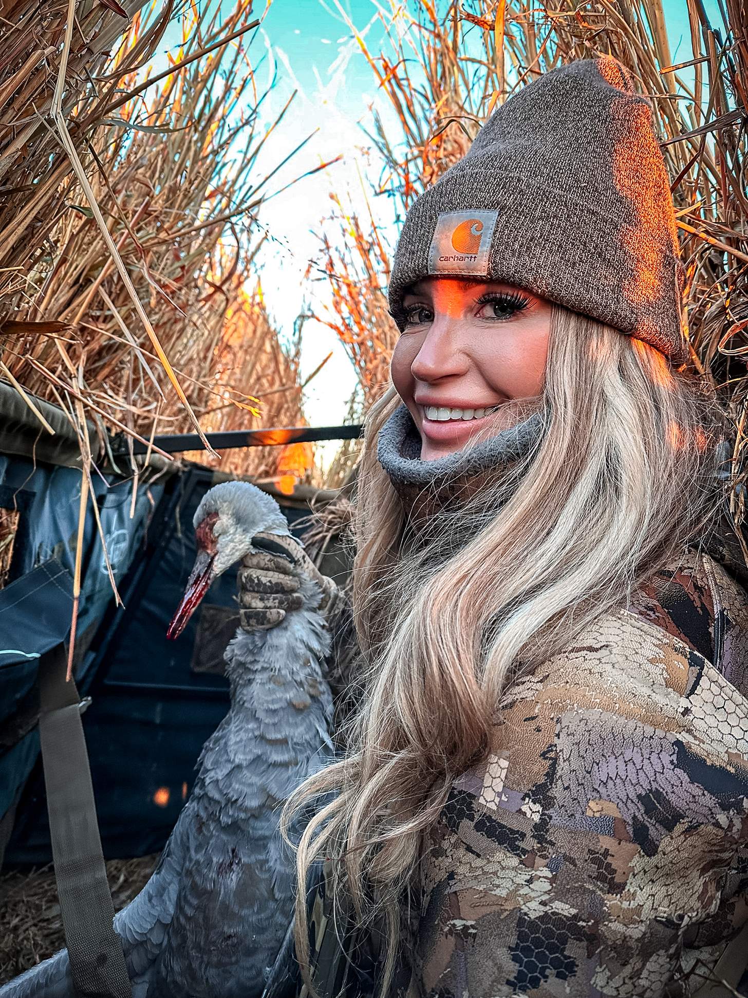 lauren brown in a duck blind with a dead duck