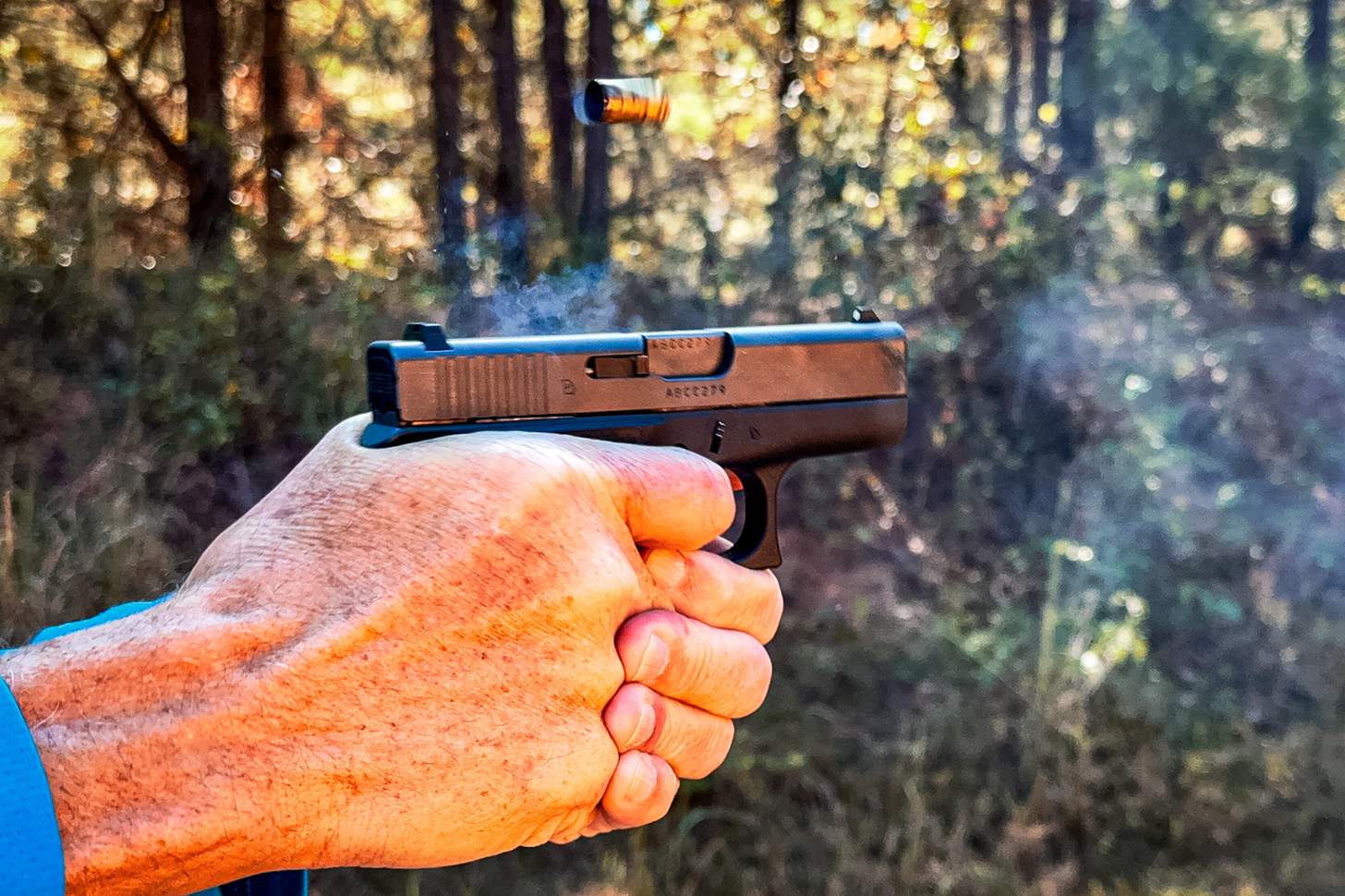 GLOCK 42 pistol being fired with ejected casing