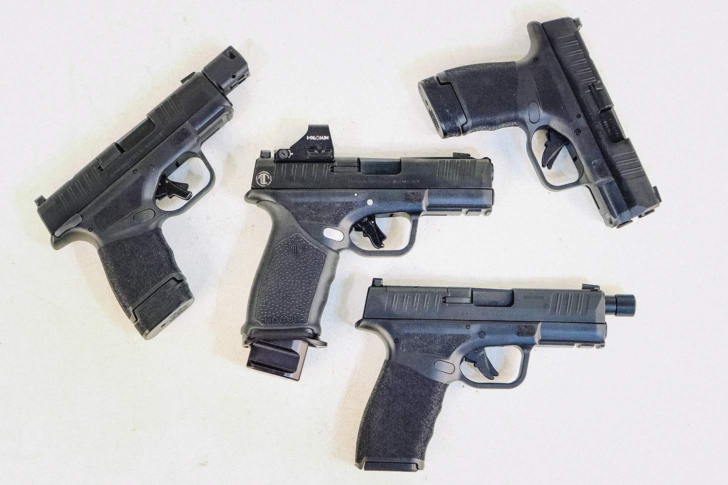 LTT Hellcat Pro with red dot with standard Hellcat, a Hellcat with a compensator, and a Hellcat Pro with a threaded barrel.