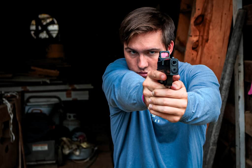 a man shooting a LTT Hellcat Pro pistol