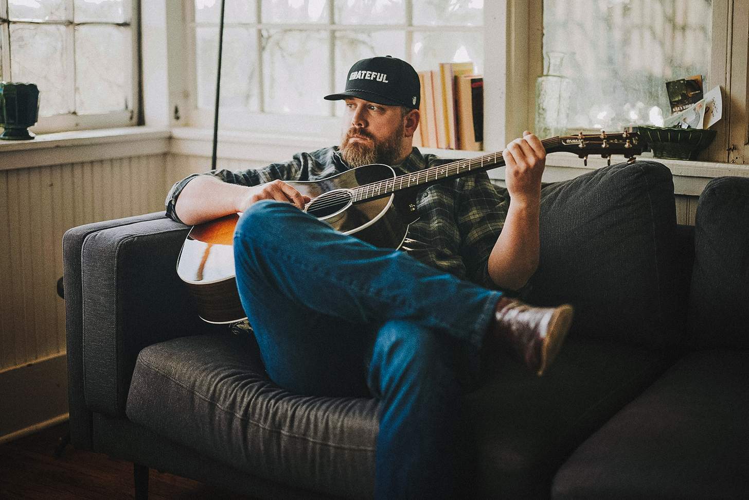 at home with his guitar