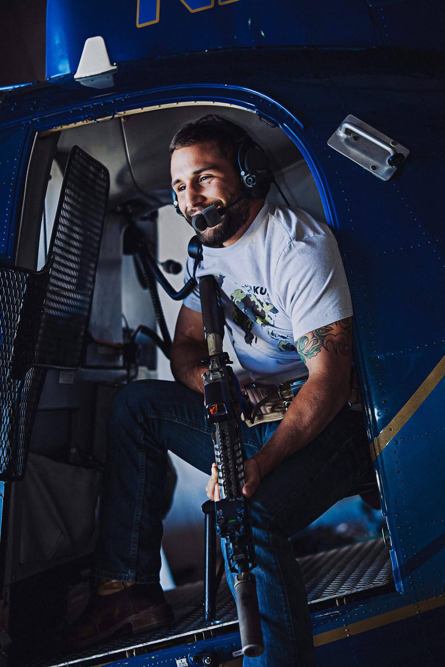 Chad Mendes shooting an AR from a helicopter