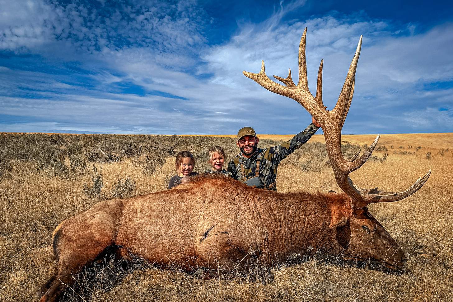Chad Mendes with kids and a bull elk