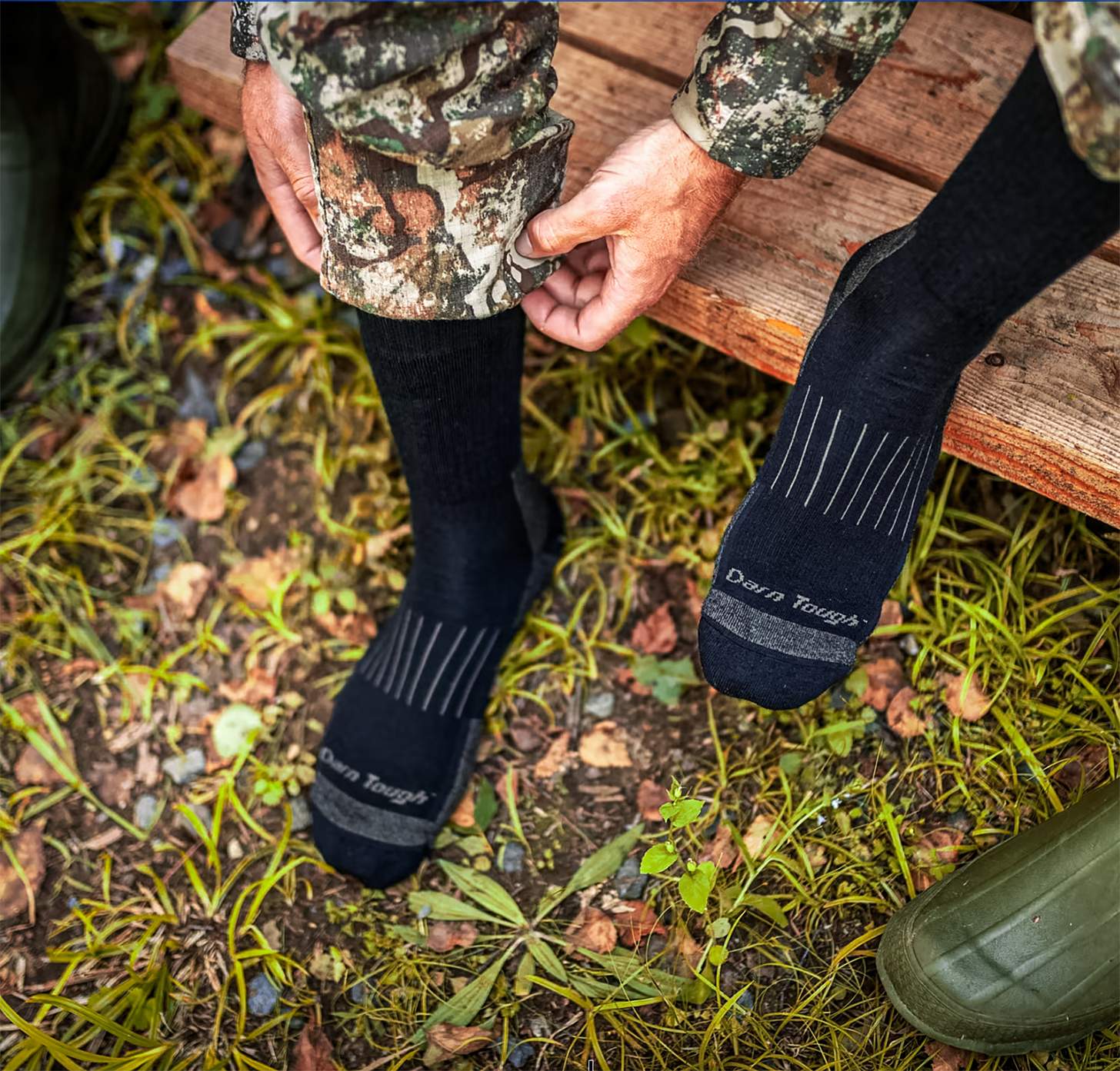 a hunter putting on darn tough socks