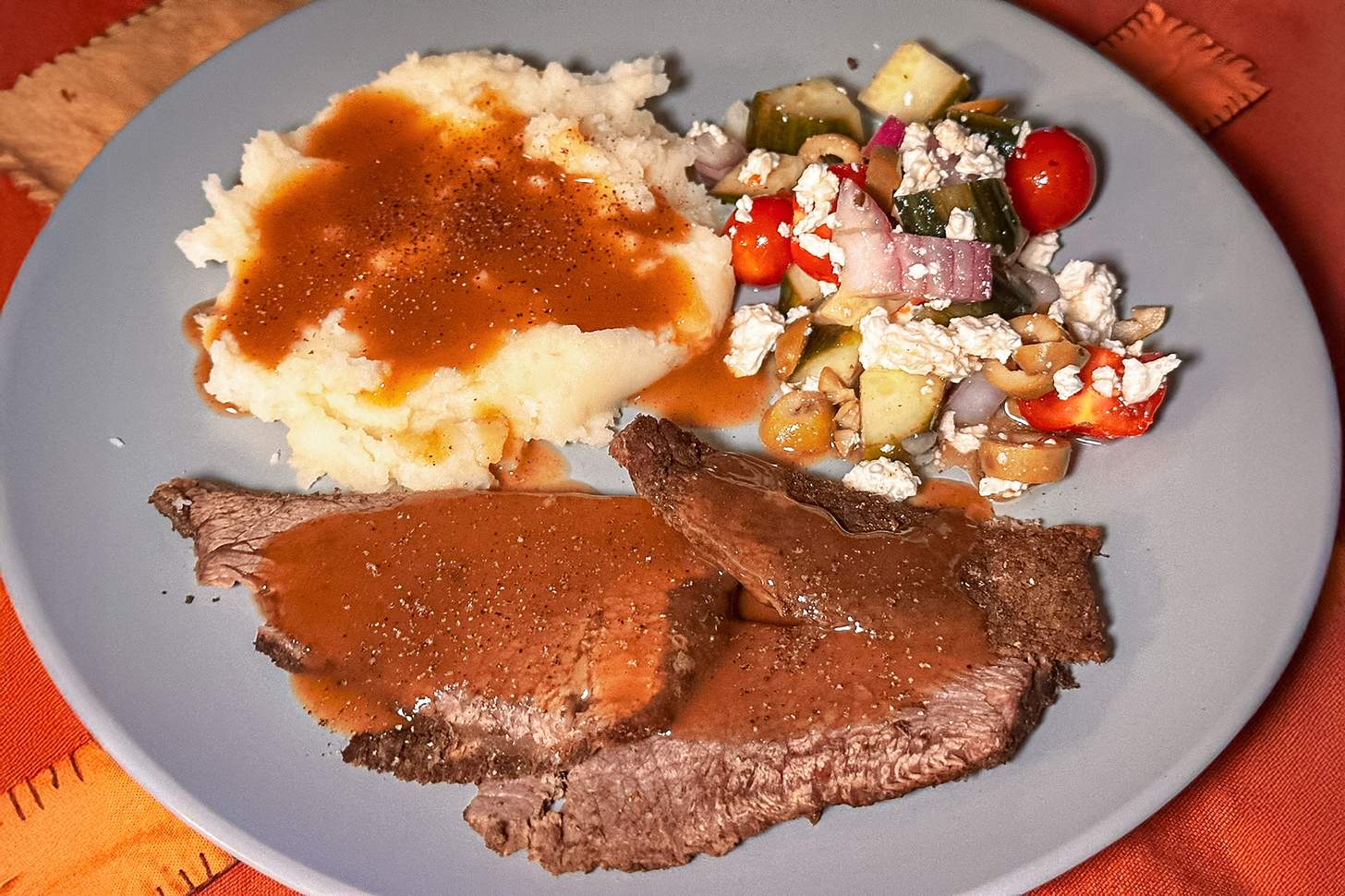 moose pot roast plated with mashed potatoes, gravy, and salad