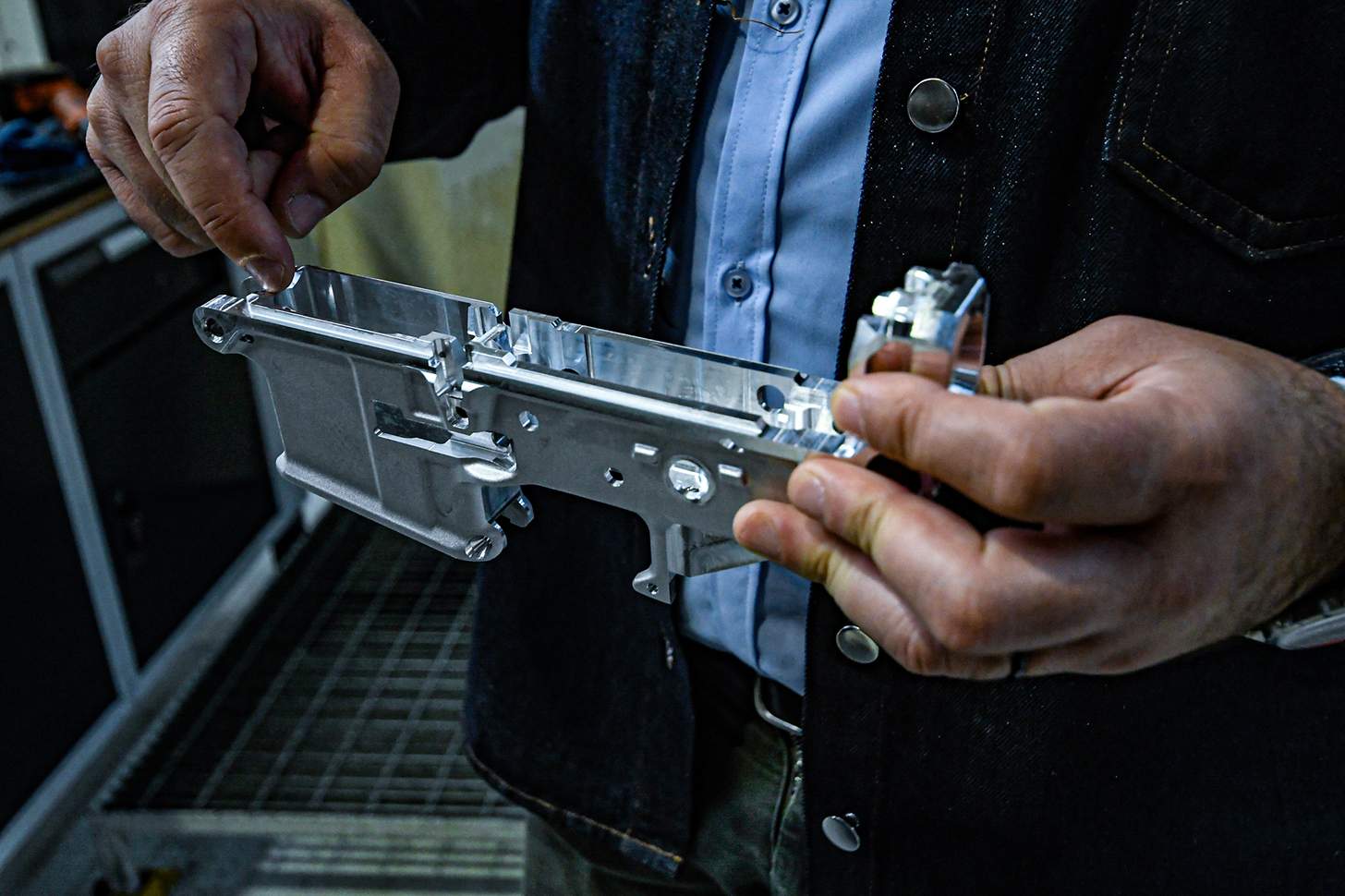 man holding an AR lower receiver 