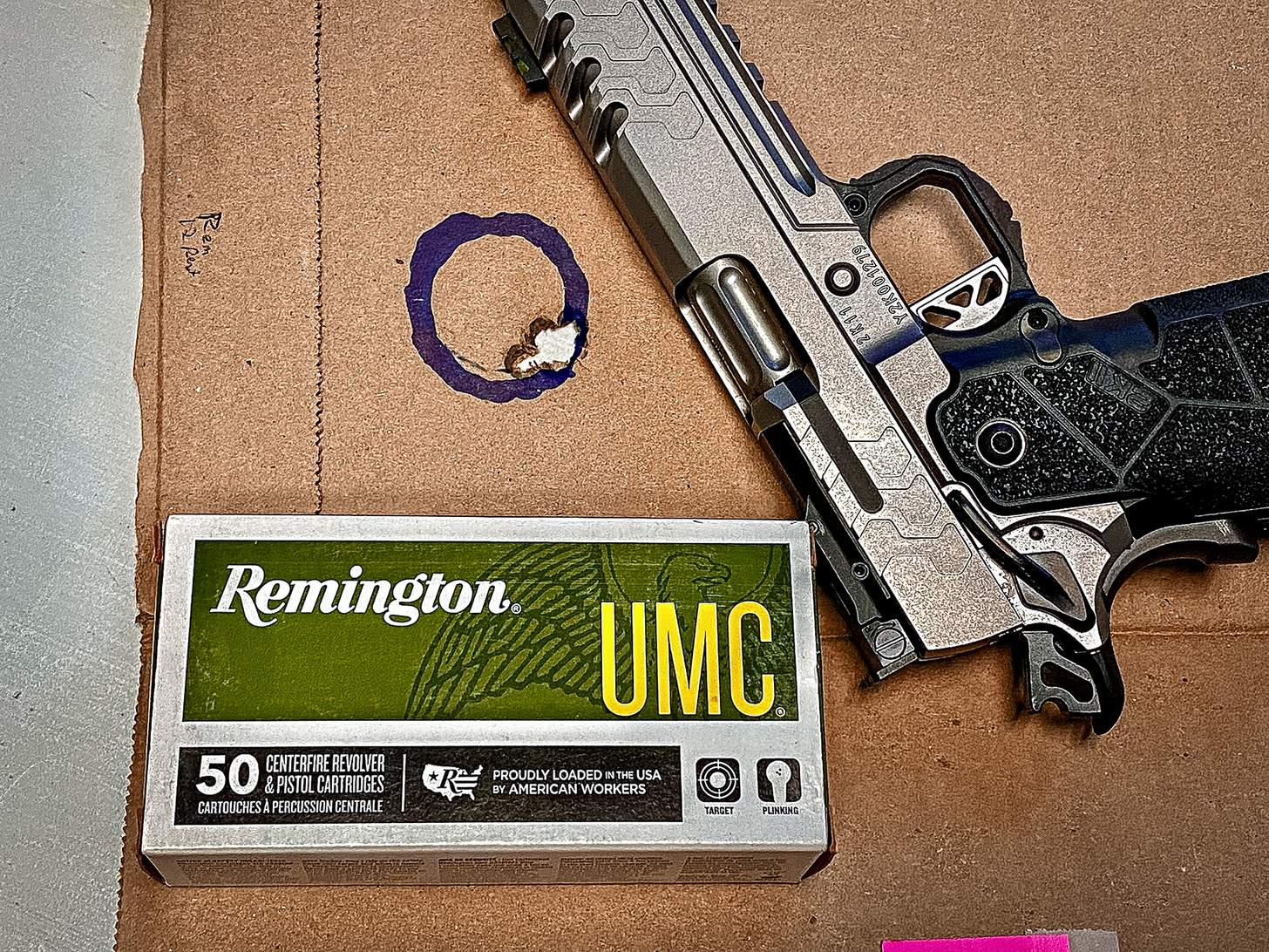 Kimber 2K11 Stainless Comp with Remington UMC ammo and target